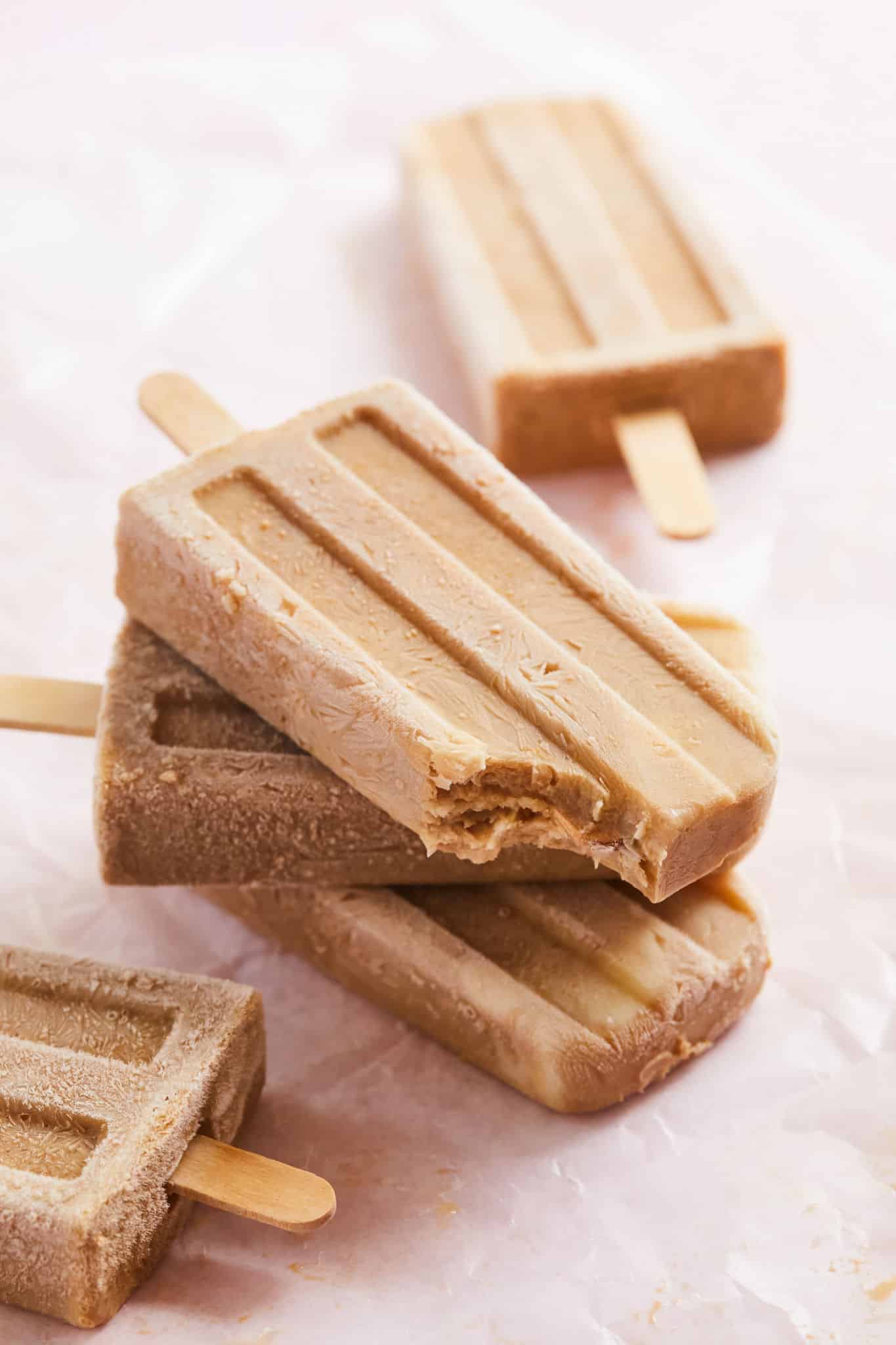 An Irish coffee popsicle with a bite taken out of it.