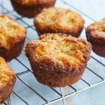 Kouign-Amann on a cooling rack. They're golden brown with flakey layers.