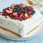 A tres leches cake piled with fresh berries.
