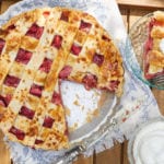 A strawberry pie with a piece removed.
