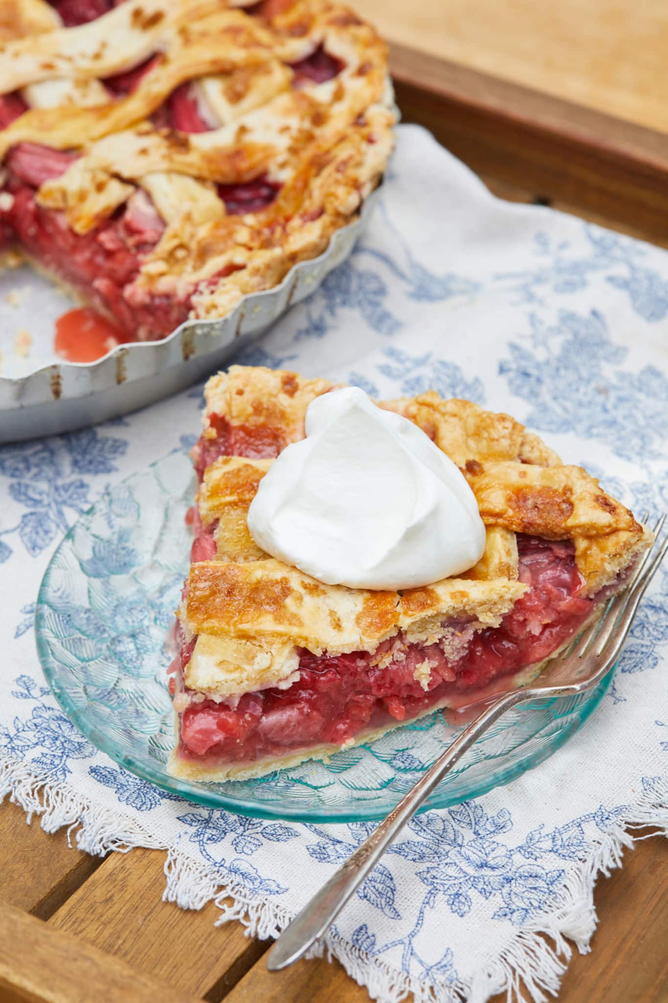 A slice of my easy strawberry pie recipe with a dollop of whipped cream on top.