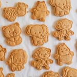 Homemade Animal Crackers arranged in a grid on some parchment.