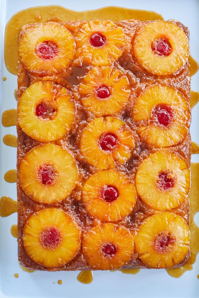 An entire pineapple upside down cake, with whole pineapple rings and cherries.