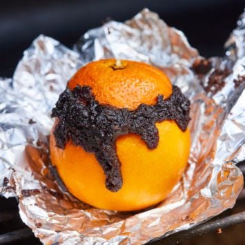 A chocolate orange sitting on tin foil.