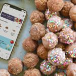 Donut holes next to an iPhone with the Pavilions app.