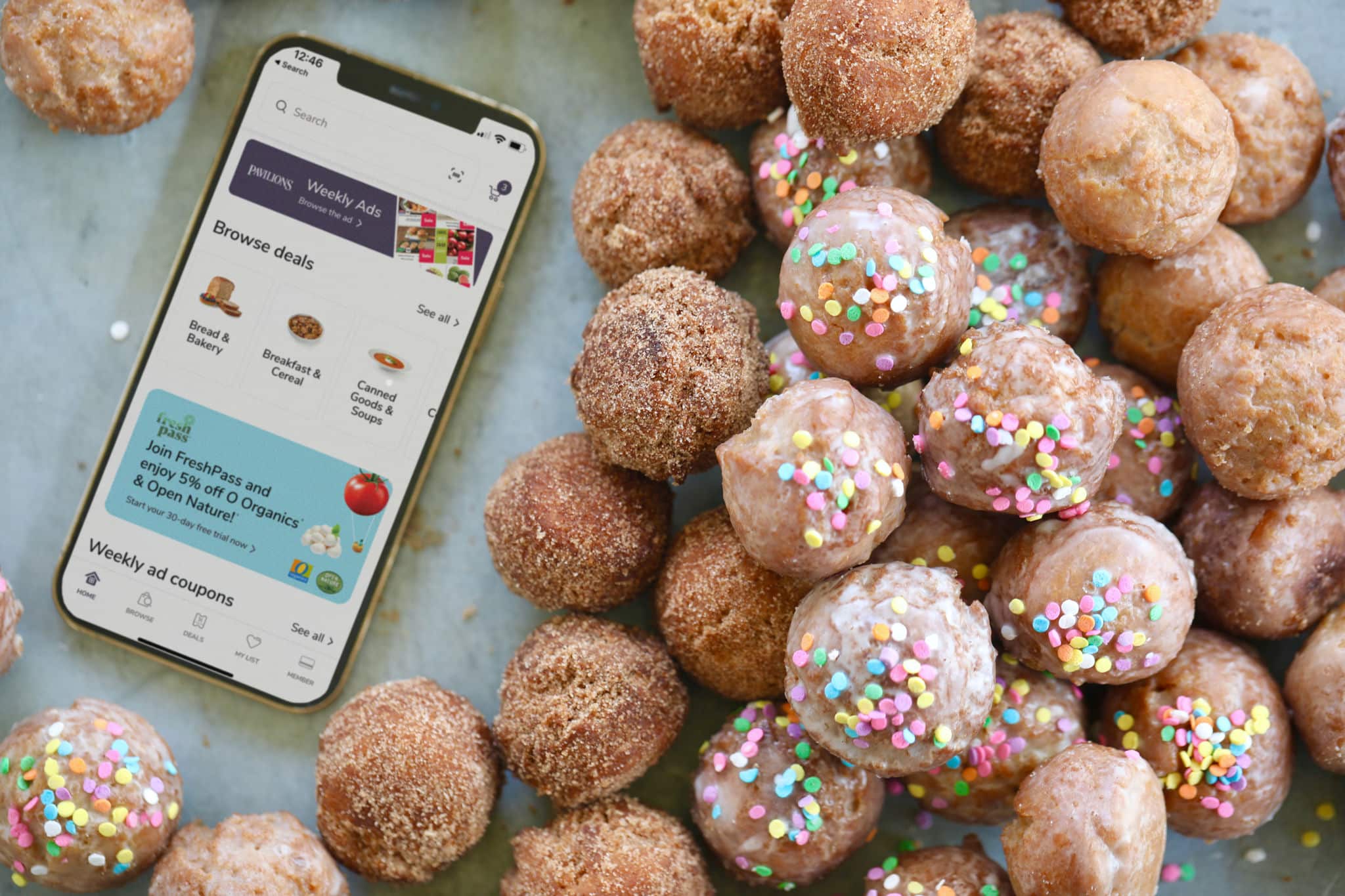 Donut holes next to an iPhone with the Pavilions app.