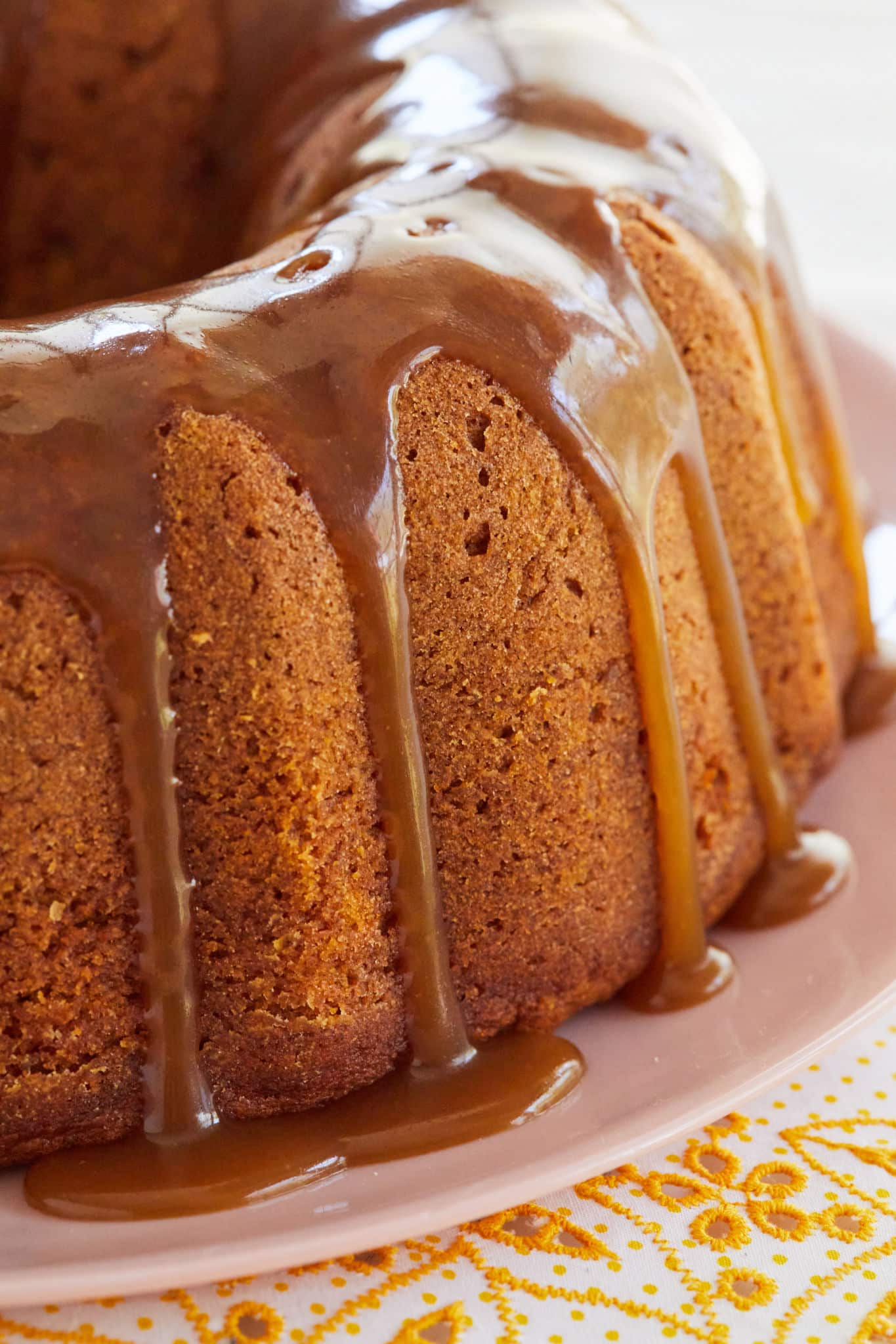 A close up of the brown sugar glaze dripping down my pumpkin bundt cake recipe.