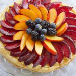 A summer tart topped with fruit and pastry cream.