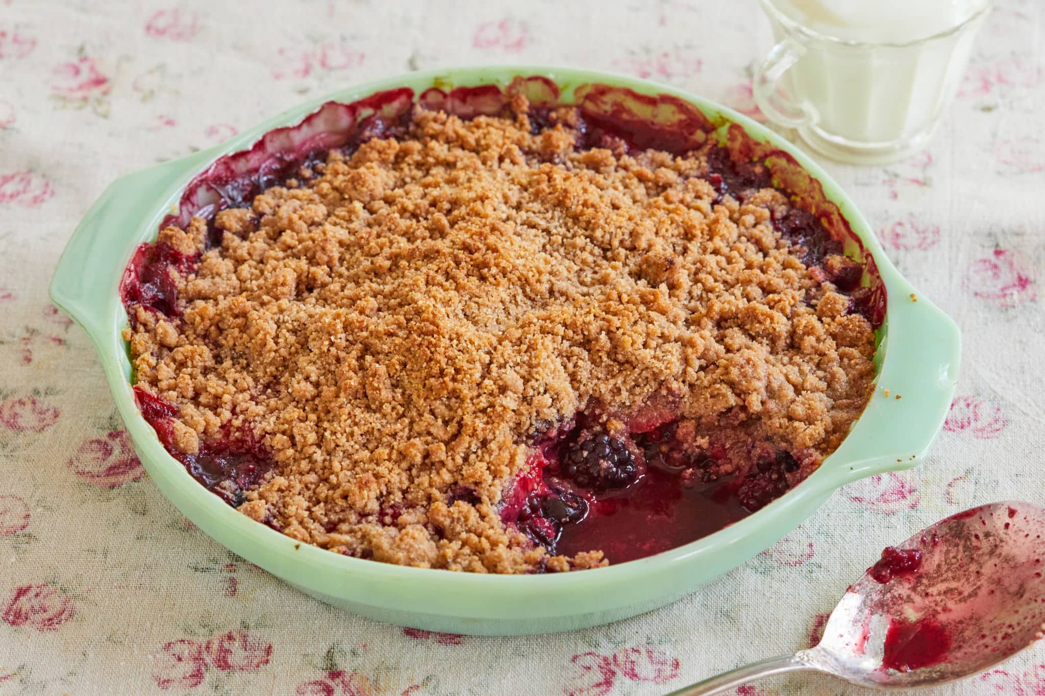 A pie dish with berry crisp.