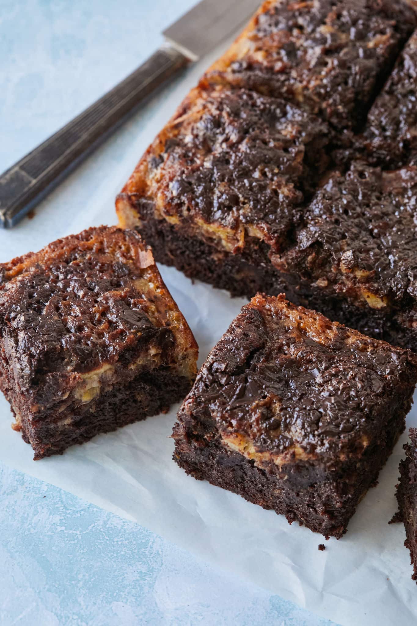 A close-up shot at generous squares of gooey chewy banana Bread Brwonies.