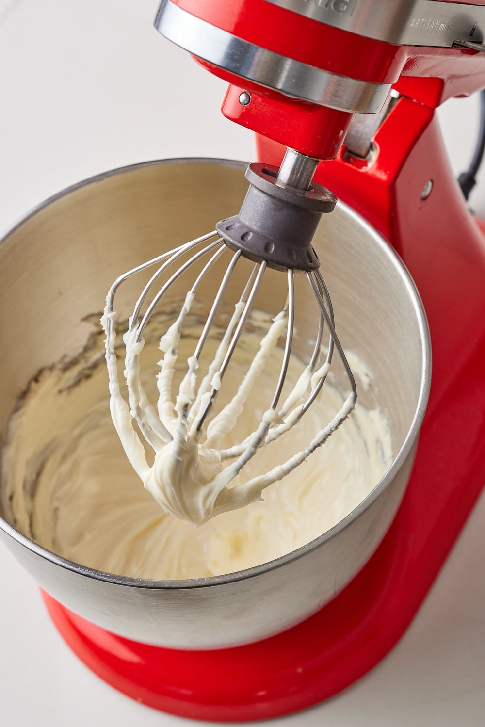 Whip up butter and milk in a stand mixer for Chocolate Buttercream frosting. 