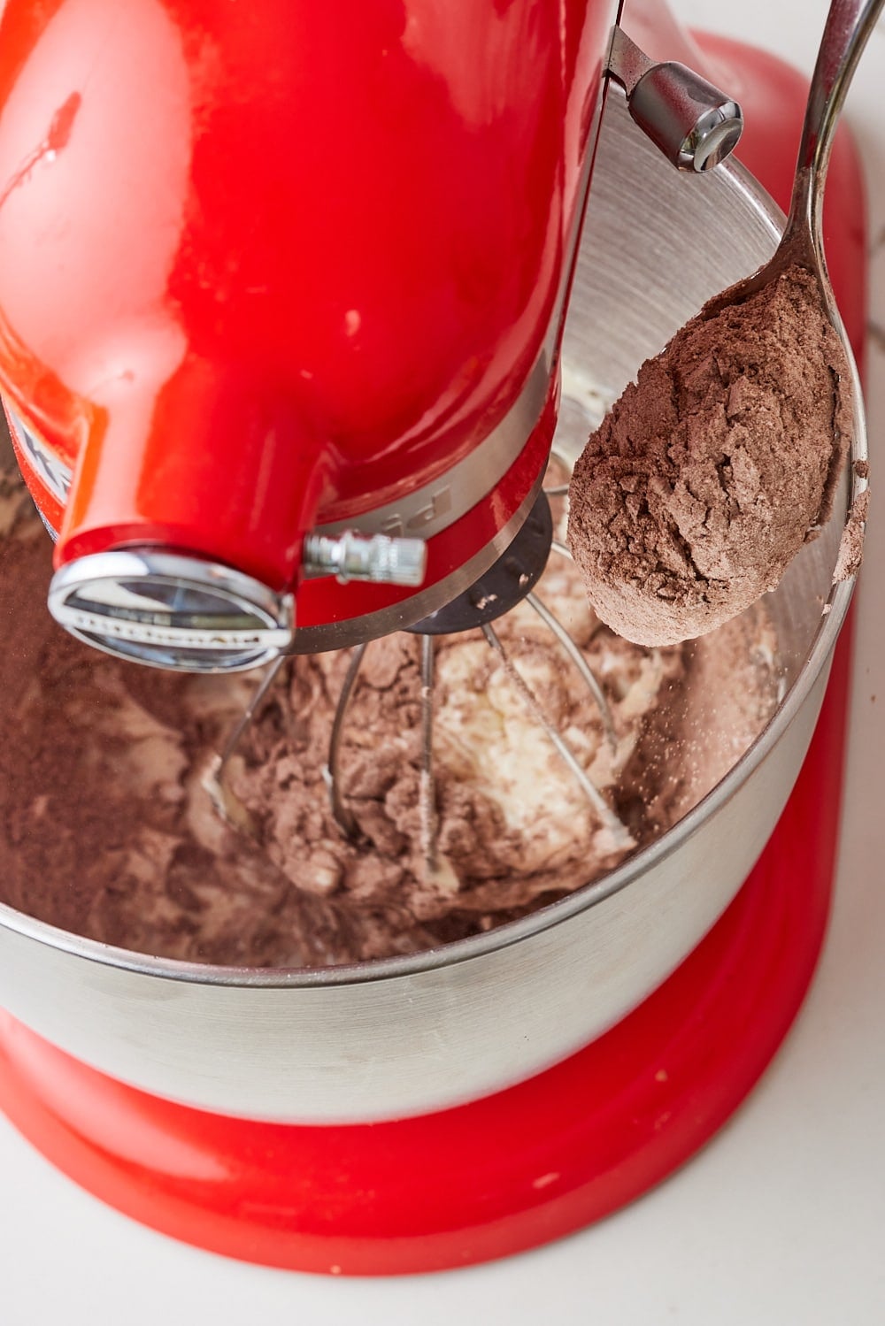 Add powdered sugar and cocoa powder gradually until full incorporated. 