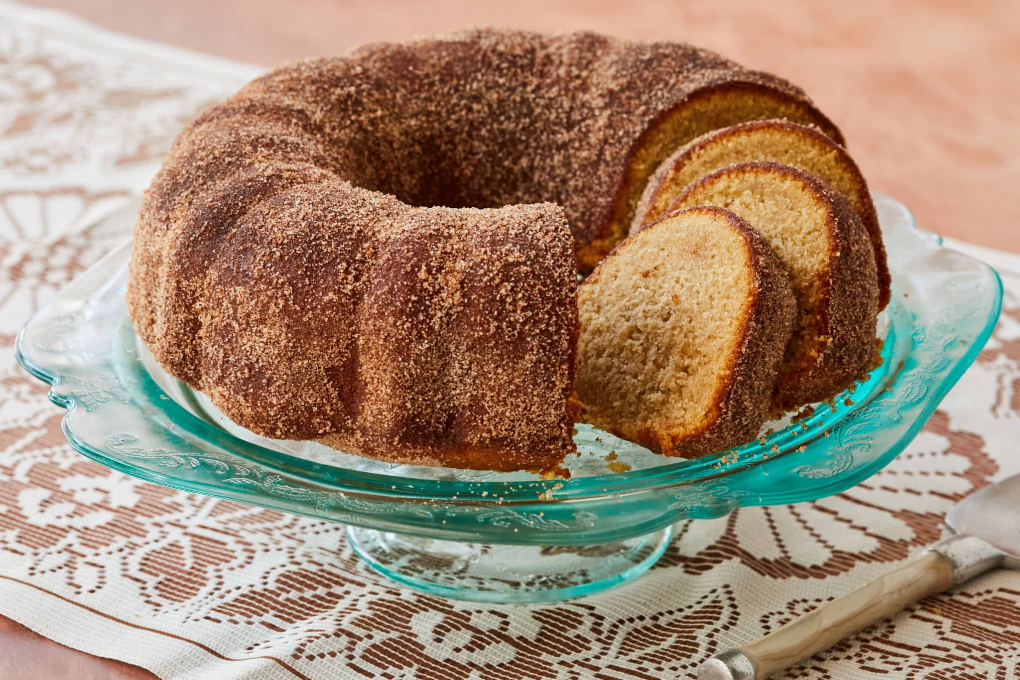 An apple cider donut cake covered in cinnamon sugar.