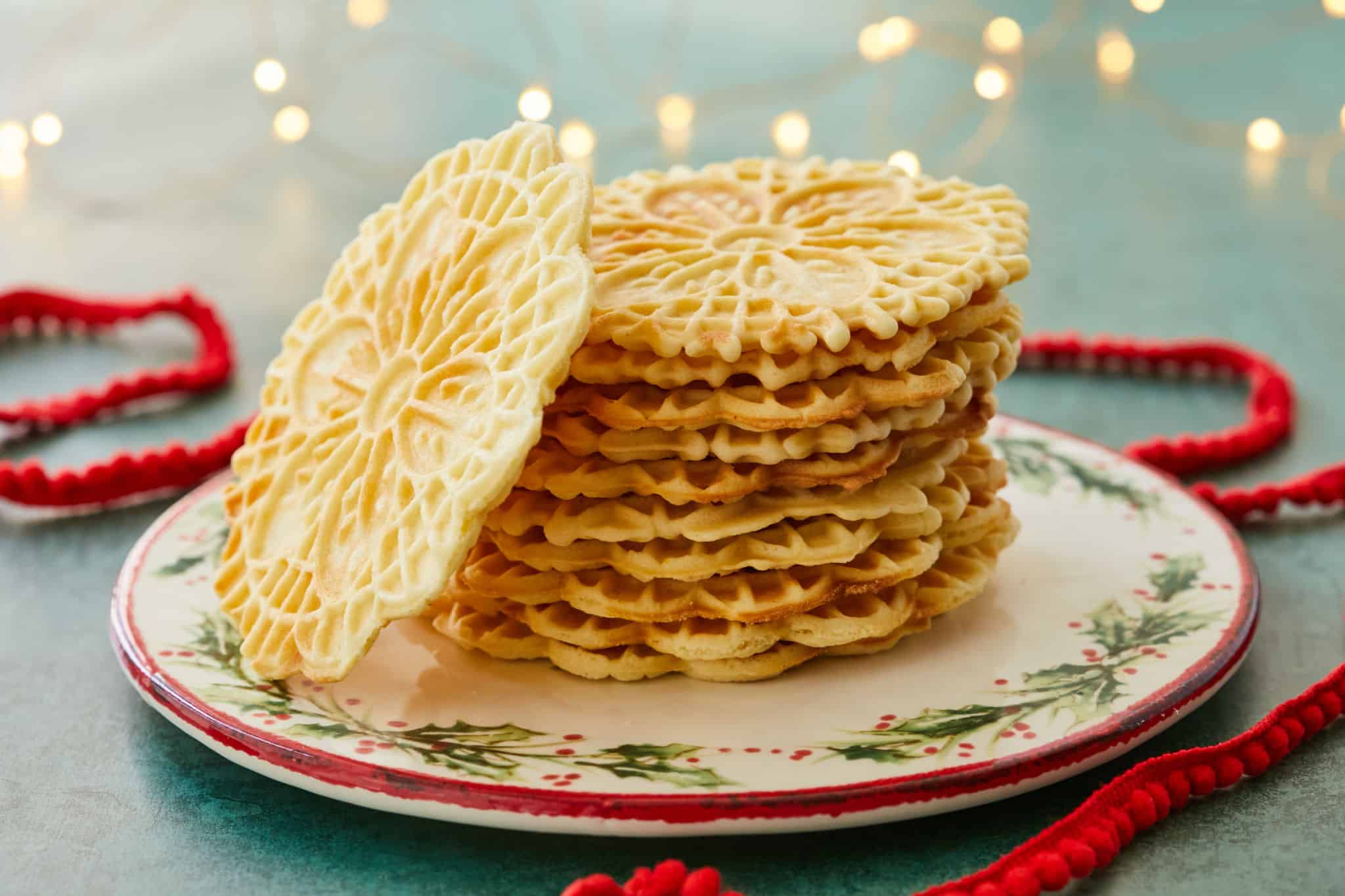Homemade Pizzelle stacked on a plate.