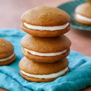 Three pumpkin whoopie pies stacked on top of each other.