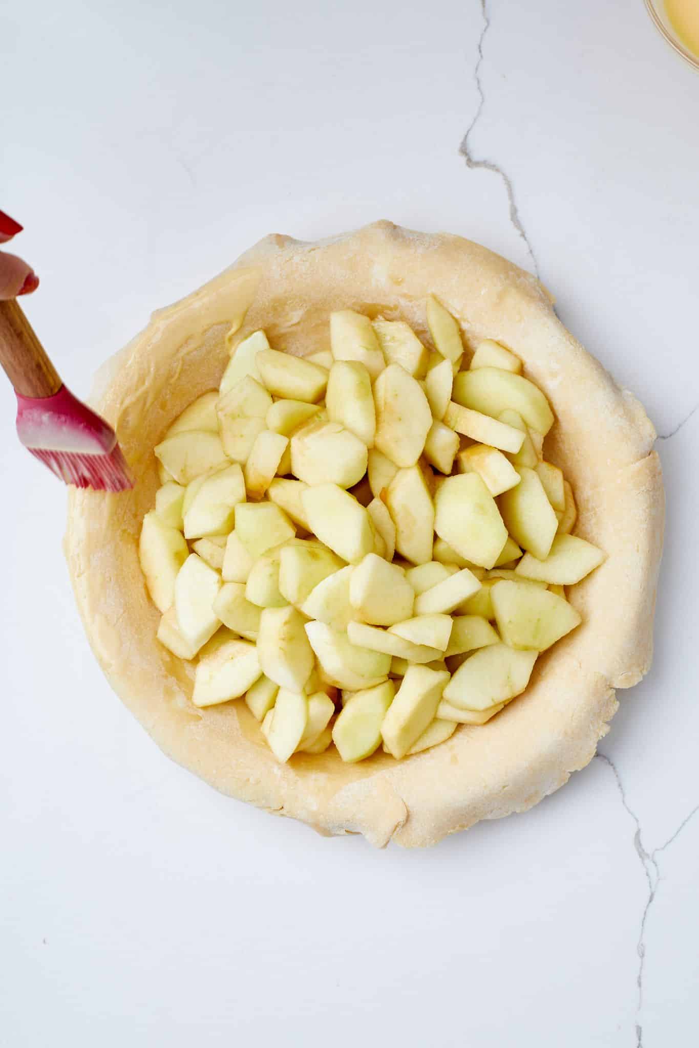 Classic Irish Apple Tart3 Pour Apple filing mixture in the bottom crust and brush the edge with egg wash.