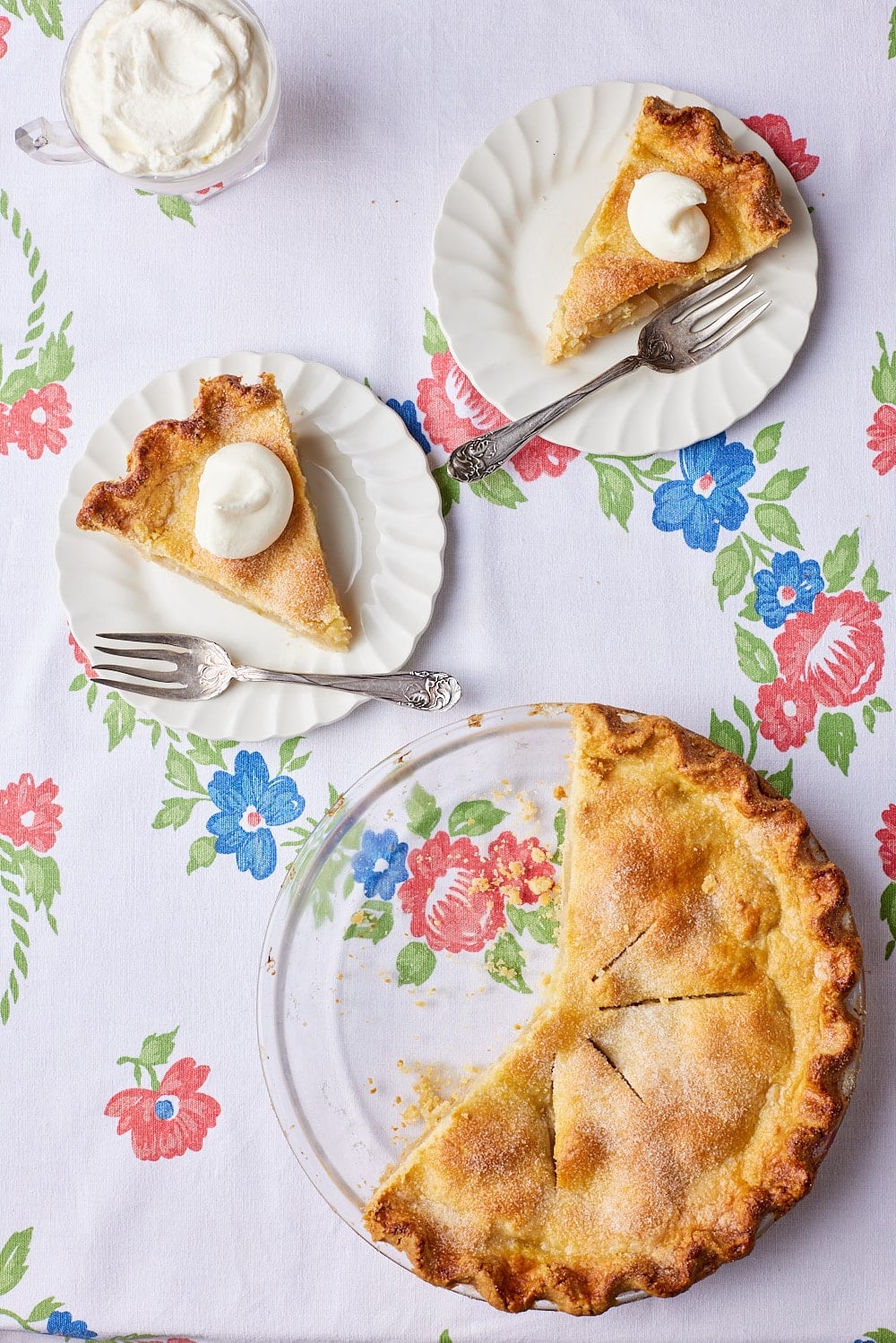 Classic Irish Apple Tart9 Top down view of two slices of Irish Apple Tart served with softly whipped cream with the remaining tart on the side.