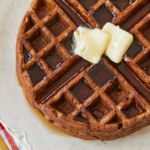 Top-down view of gingerbread waffles with butter.
