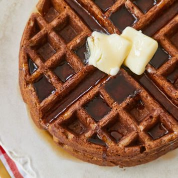 Top-down view of gingerbread waffles with butter.