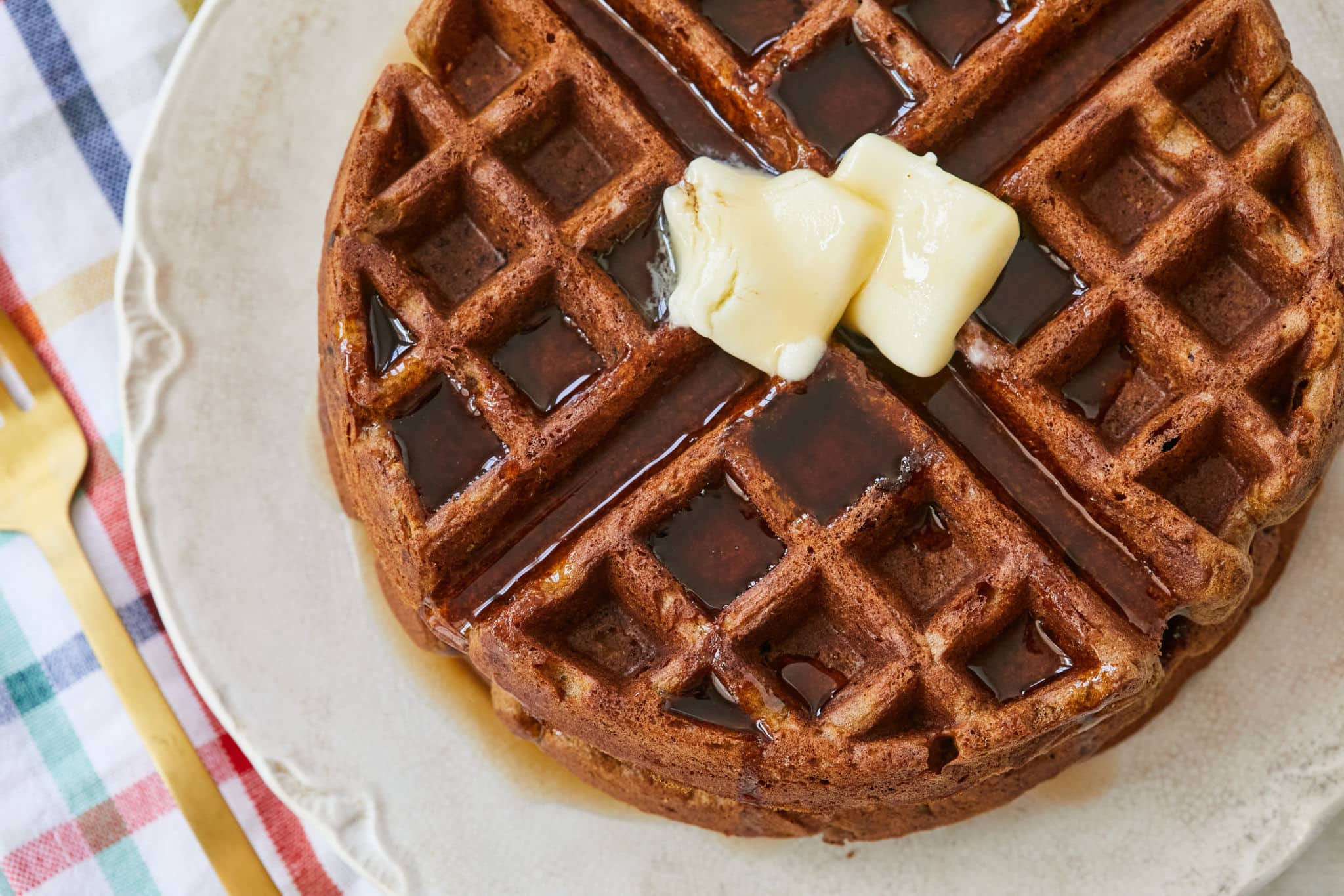 Top-down view of gingerbread waffles with butter.