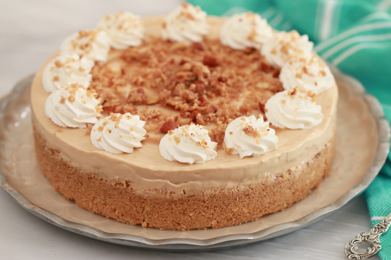 Dulce De Leche Cheesecake topped with whipped cream.