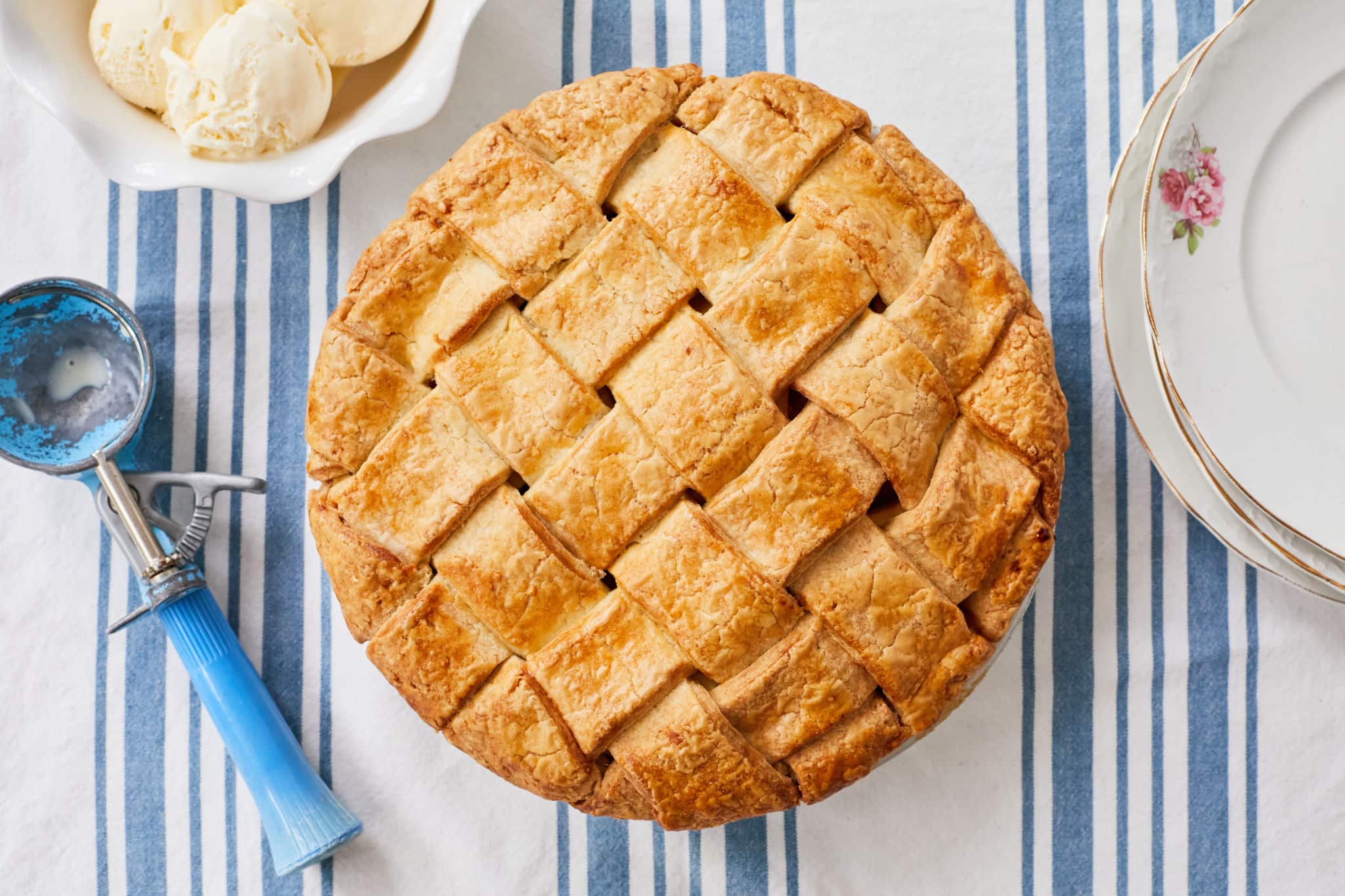 A caramel apple pie with a wide lattice top.