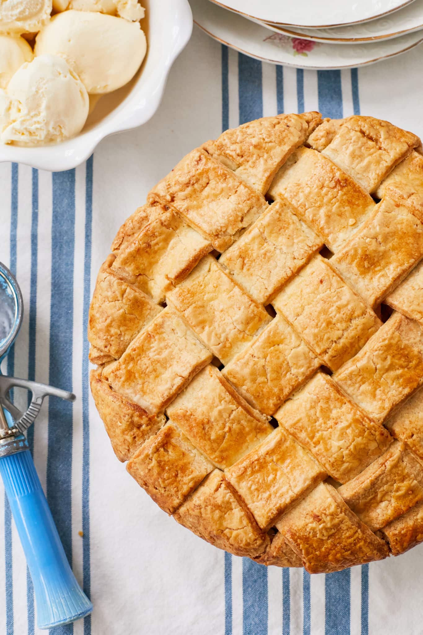 A caramel apple pie decorated with a wide lattice top.