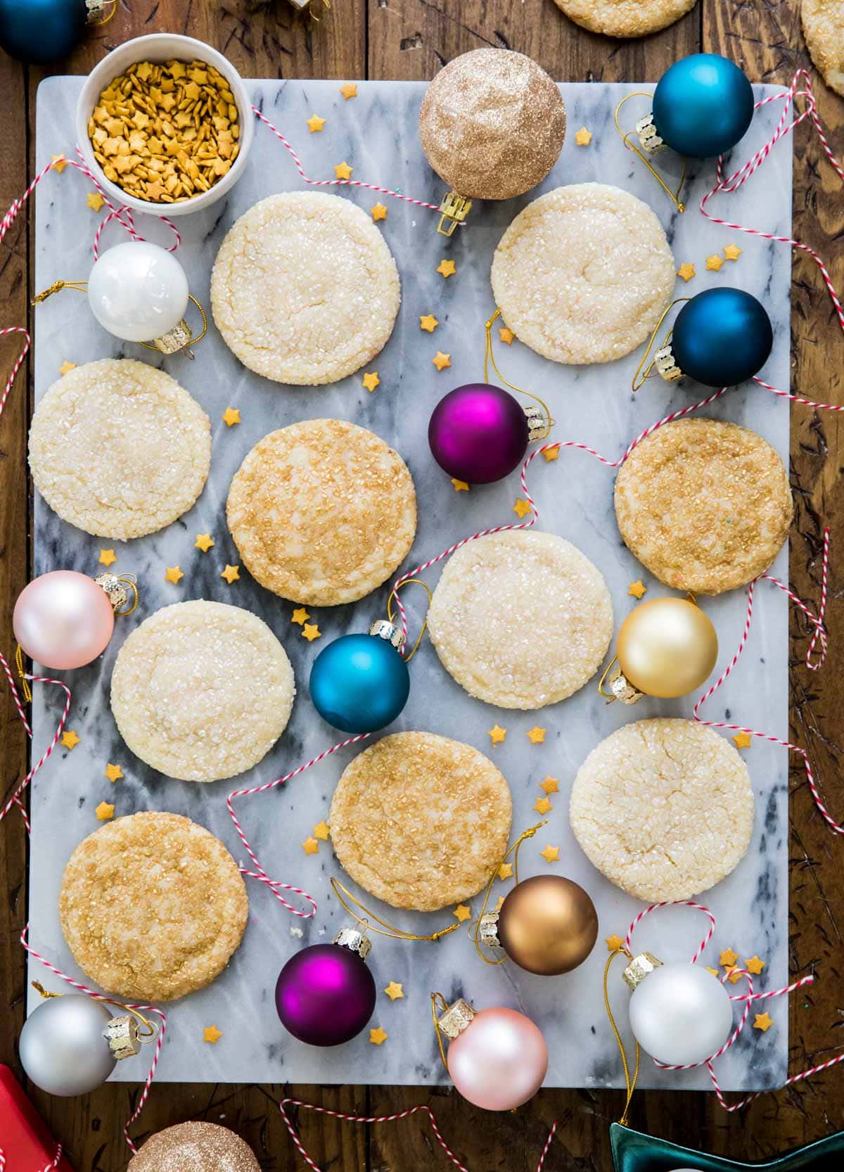 Drop sugar cookies on a platter with ornaments.