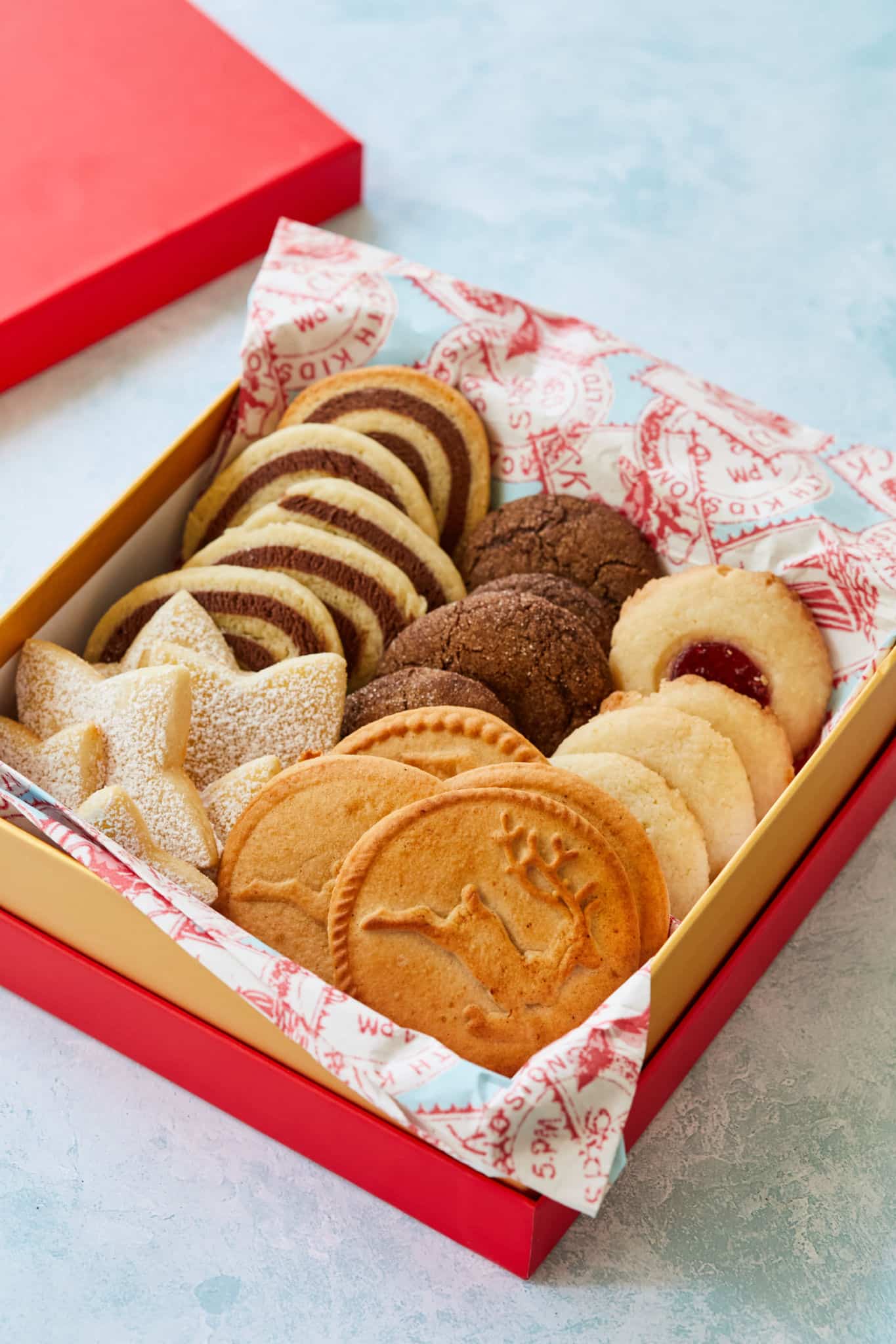 A decorative box filled with homemade holiday cookies ready to ship.