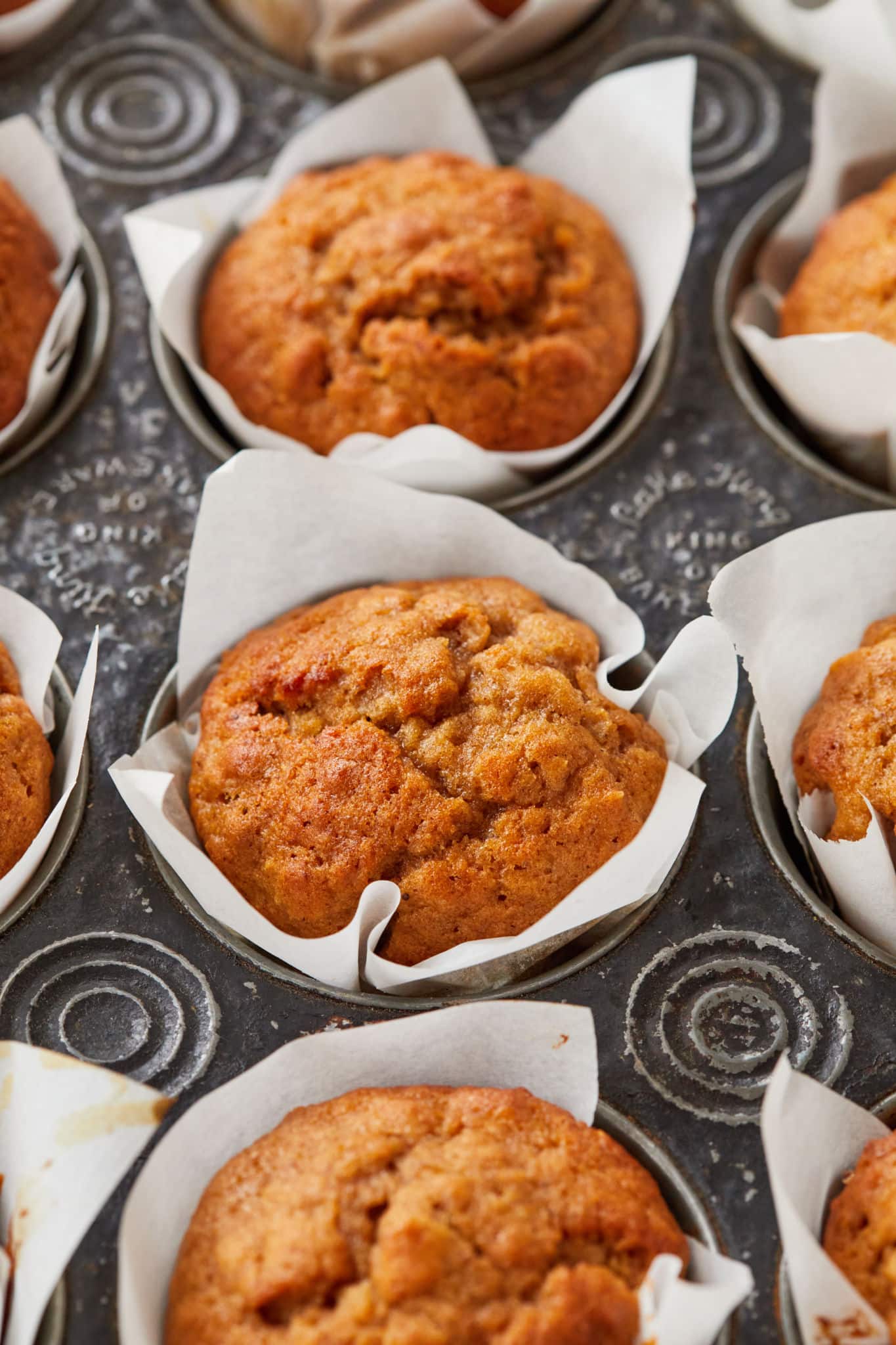 A close up of Applesauce Muffins in a tin.