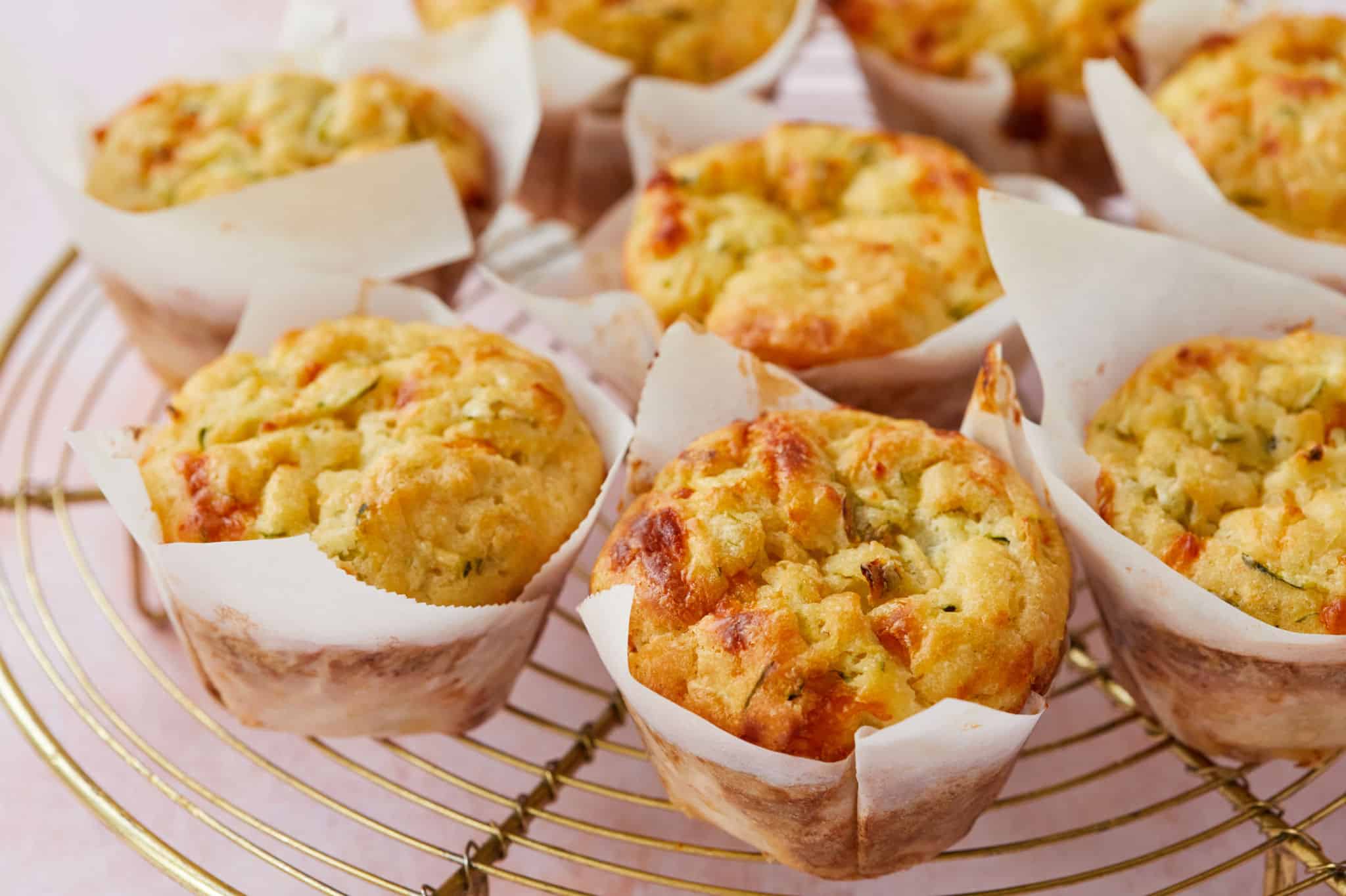 Zucchini and Cheese Muffins on a cooling rack.