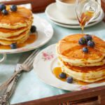 Buttermilk Pancakes For Two, served on dishes with syrup.