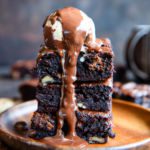 Dirty Chai Brownies stacked and topped with ice cream.