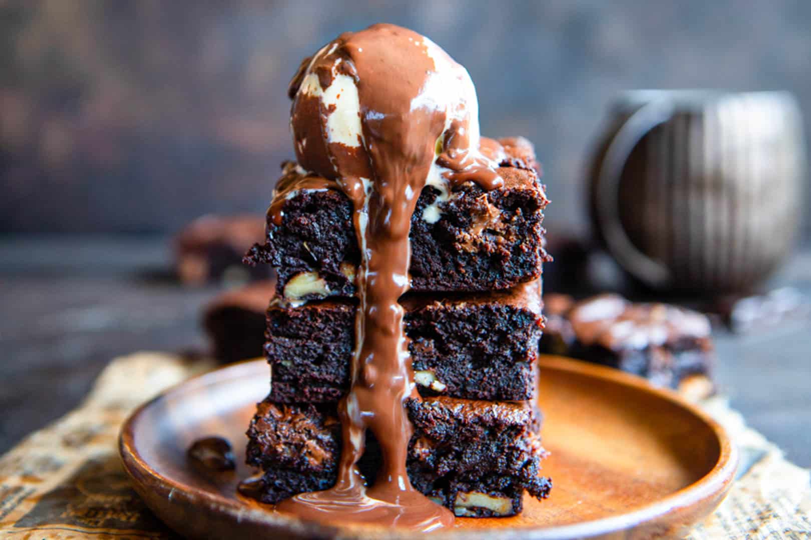 Dirty Chai Brownies stacked and topped with ice cream.