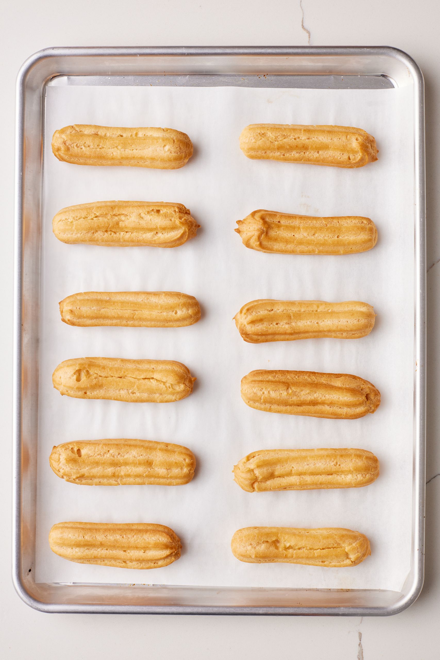 Eclairs9 Bake in two stages: Bake at 400°F (200°C) for 20 minutes. Then, without opening the oven, reduce to 325°F (160°C) and bake another 10–20 minutes until golden and hollow-sounding.
