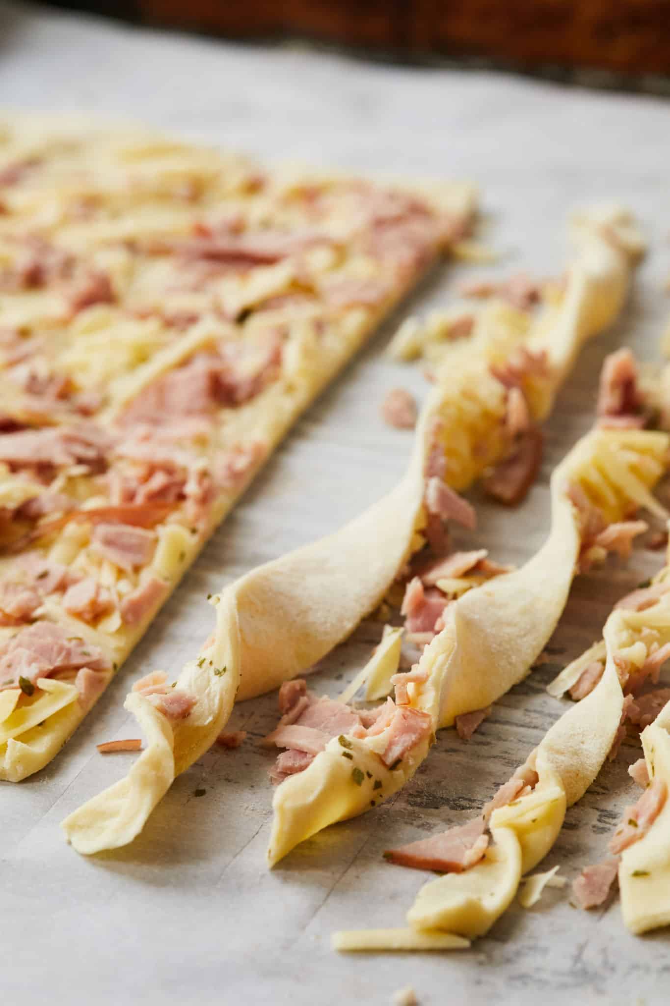 A close up of un-baked Ham and Cheese Pastry Twists