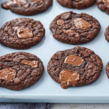 Triple Chocolate Chip Cookies on a baking sheet.