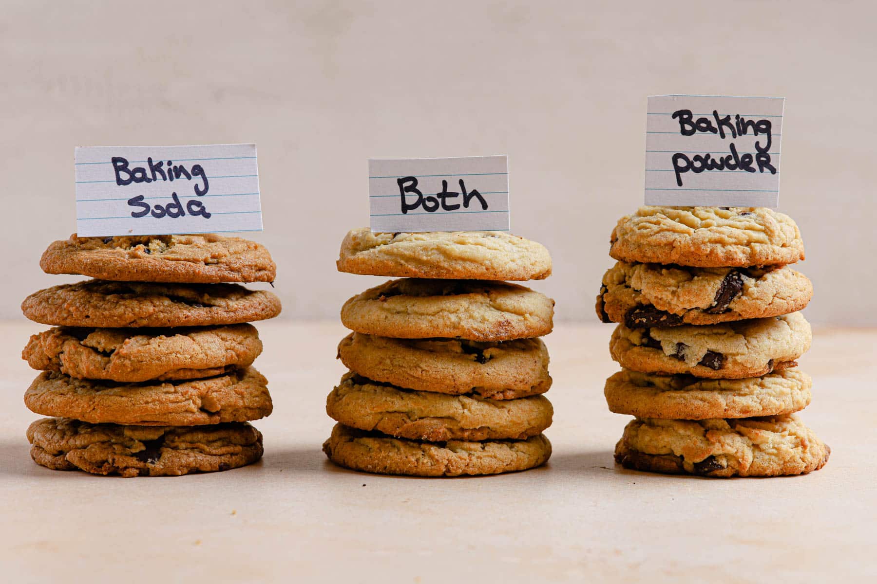 Three stacks of cookies with different ingredients.