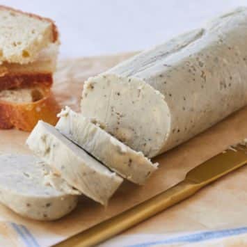 Sliced Blue Cheese Compound Butter next to bread.