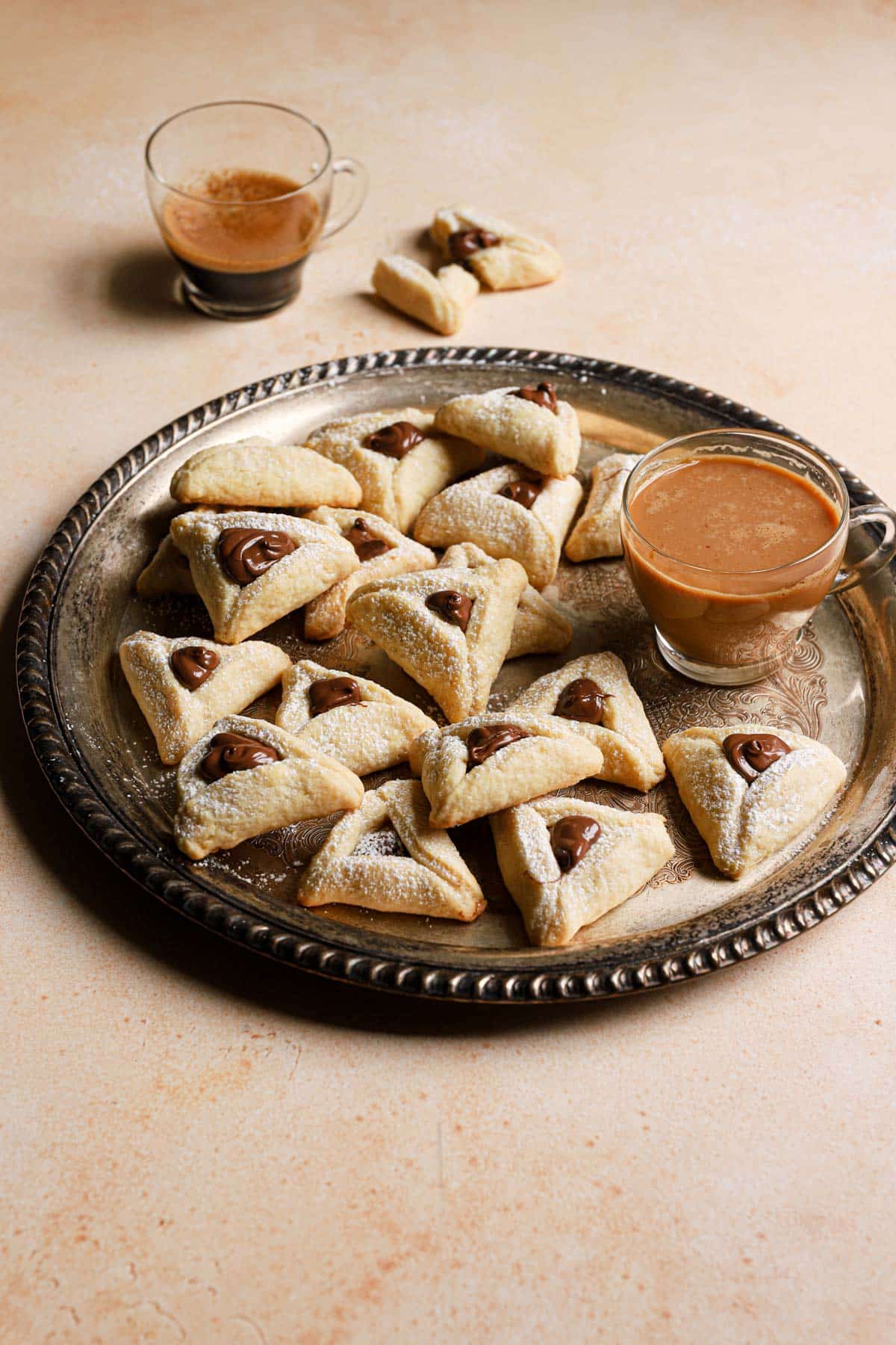 Finished Hamantaschen cookies with dipping sauce.