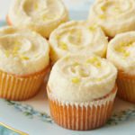 A plate of cupcakes with lemon ermine frosting.