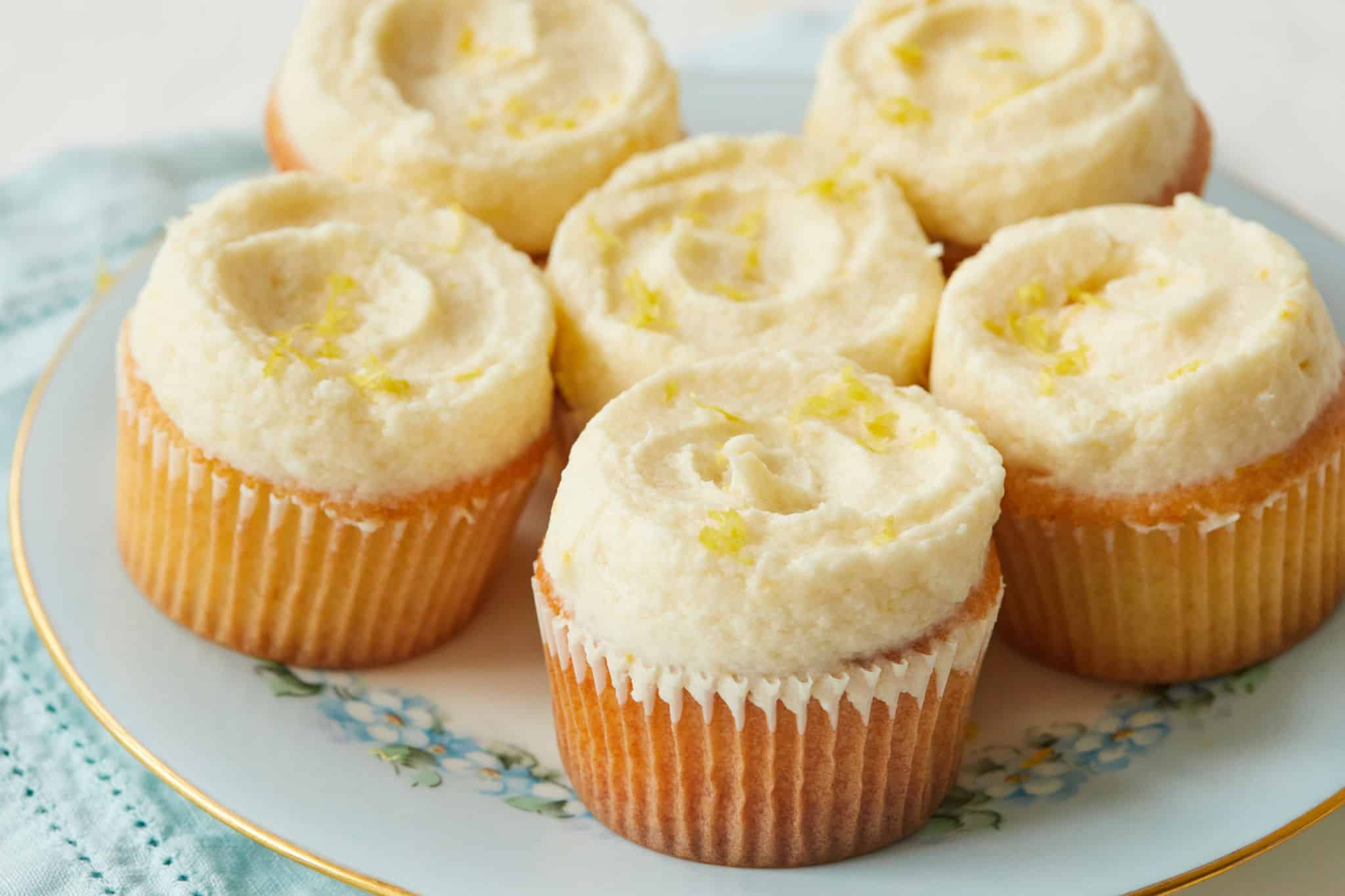 A plate of cupcakes with lemon ermine frosting.