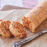 Sun-Dried Tomato Compound Butter sliced next to a knife.
