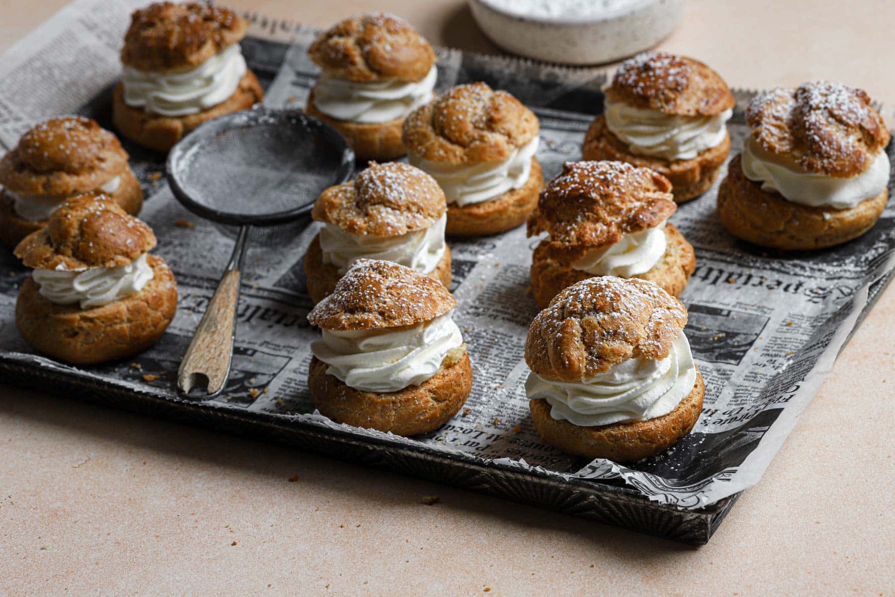 Cream Puffs sitting on a baking tray.