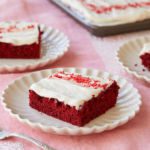 Red velvet sheet cake slices on dishes.