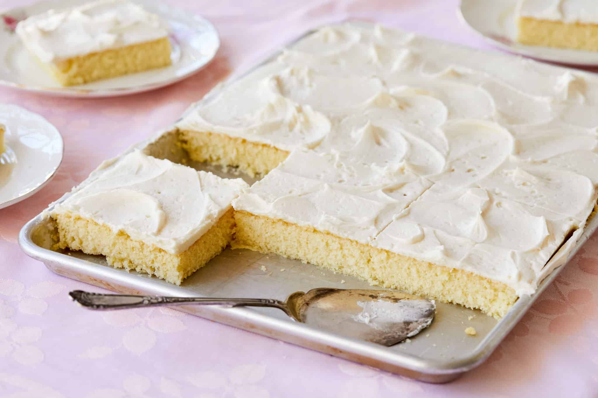 A vanilla sheet cake with slices served