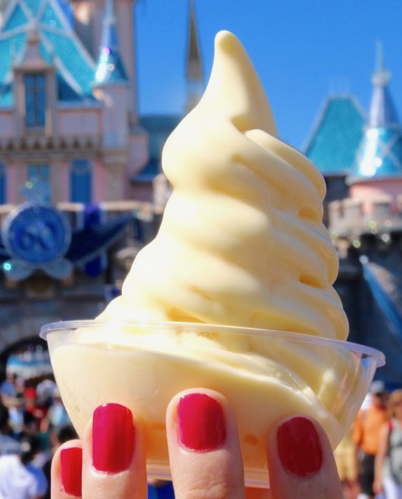 Dole whip in a cup being held up by a hand