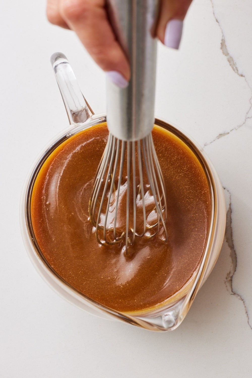 A wish stirring the caramel sauce. 