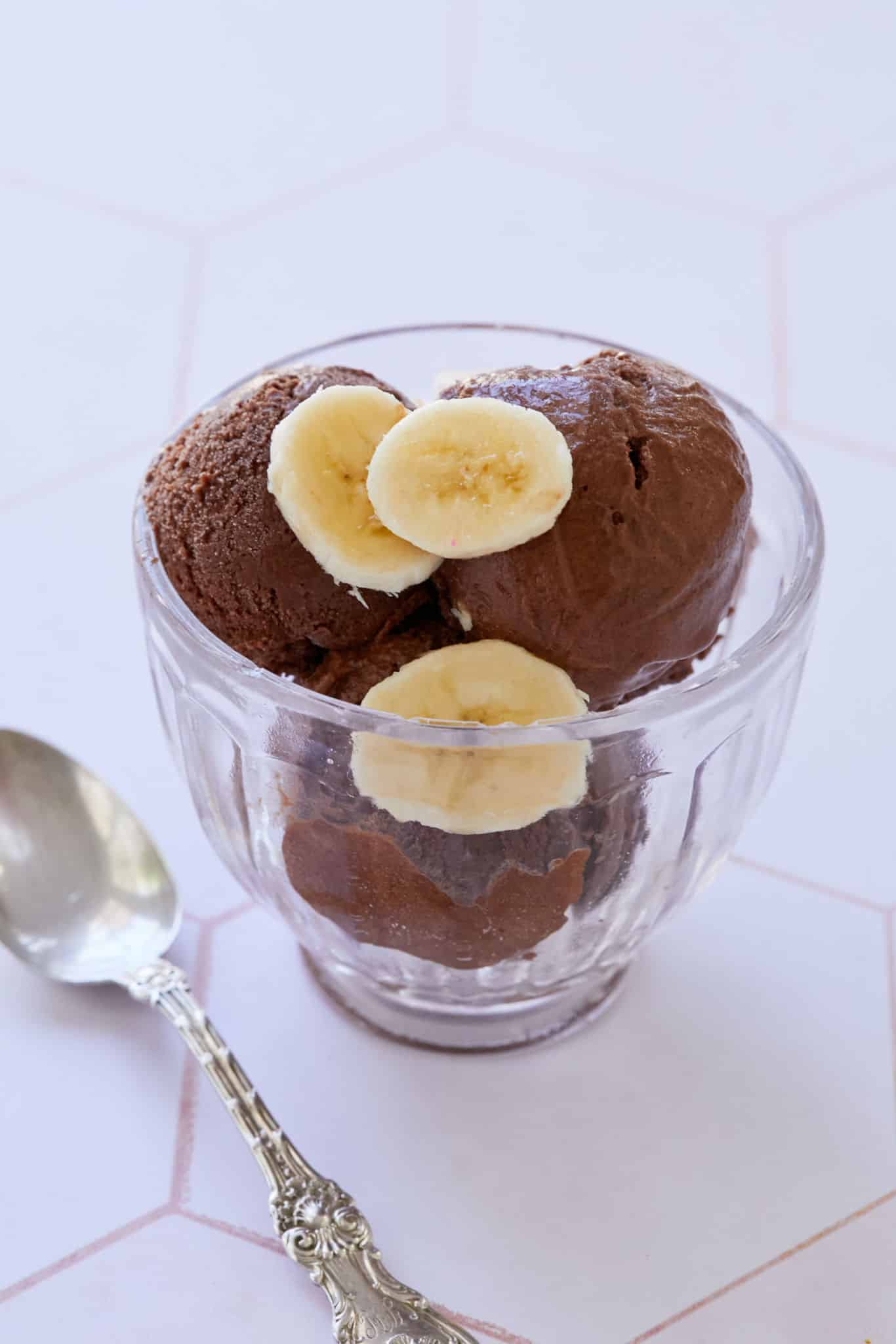 Fresh bananas top healthy chocolate ice cream, made with frozen bananas and dates.
