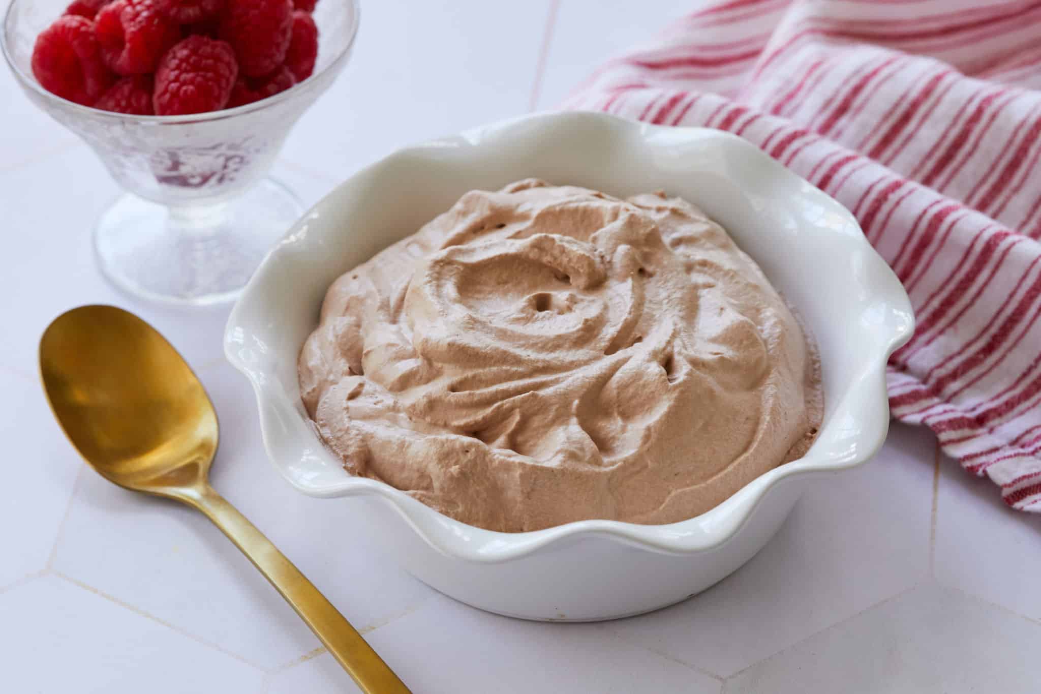 A white bowl filled with cream chocolate whipped cream.